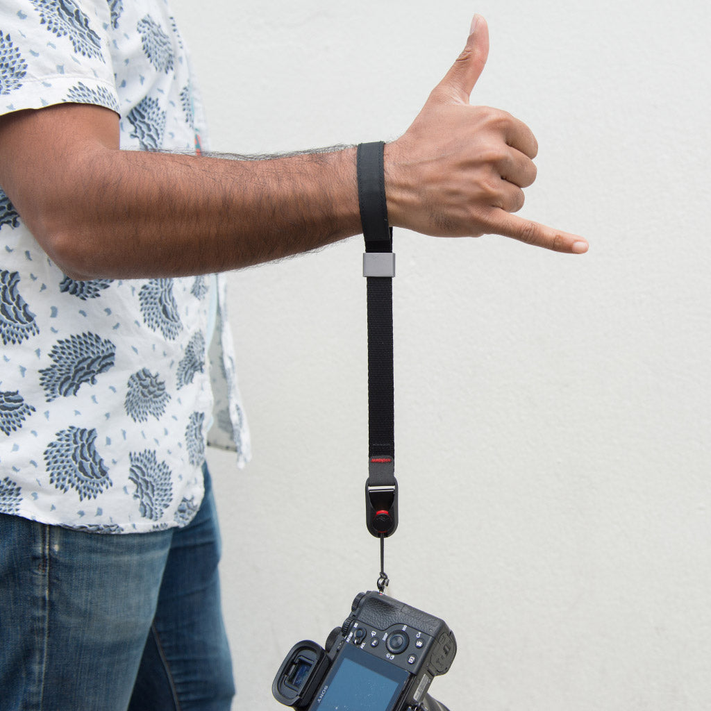 cinched black cuff on wrist when camera was dropped cinched black cuff on wrist when camera was dropped