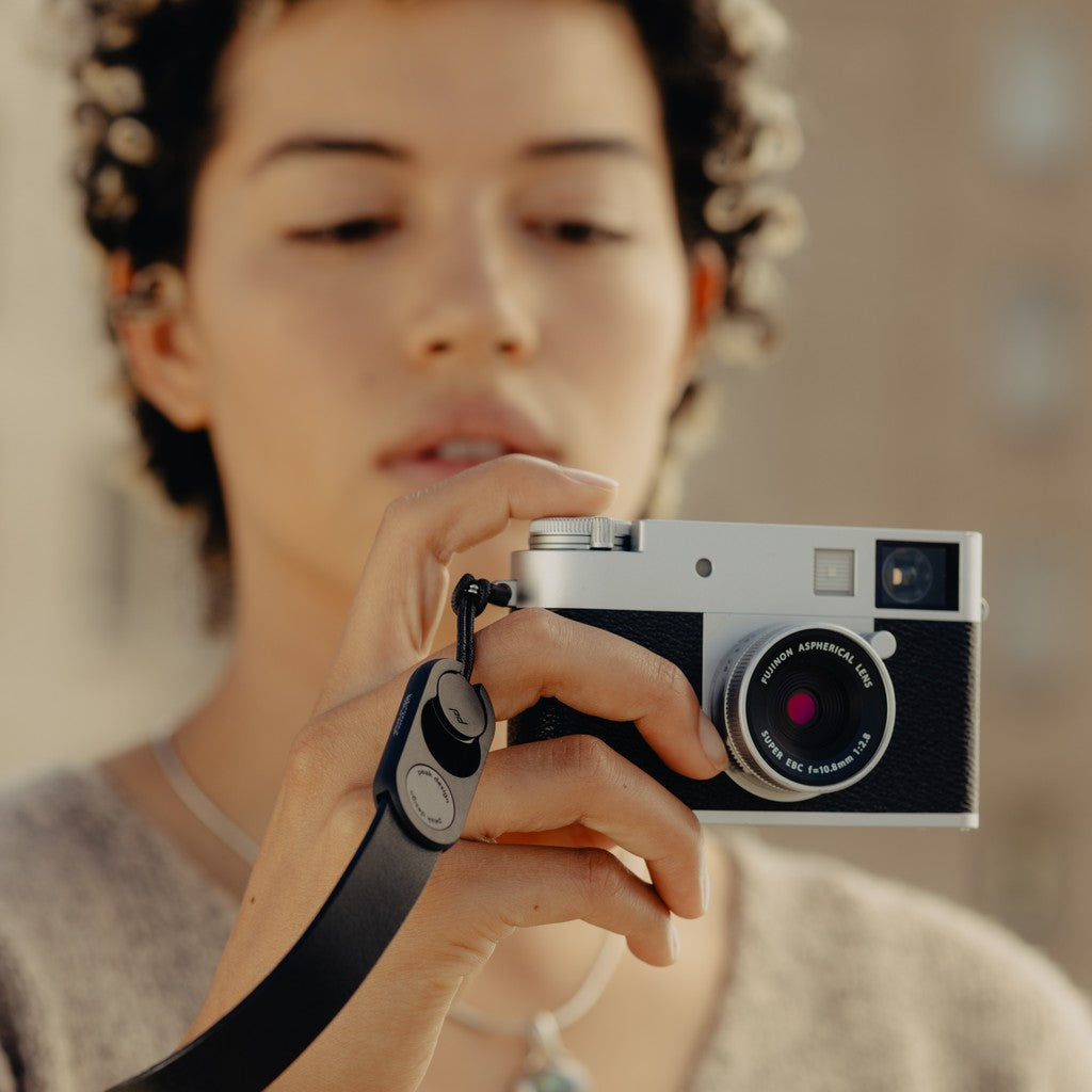 Person holding a camera with a blurred background Person holding a camera with a blurred background